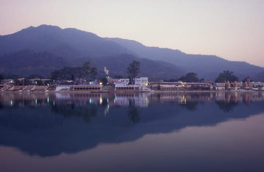 the Holy Ganges River with the city of Rishikesh in the Province Uttarakhand in India.  India, Rishikesh, February, 1998