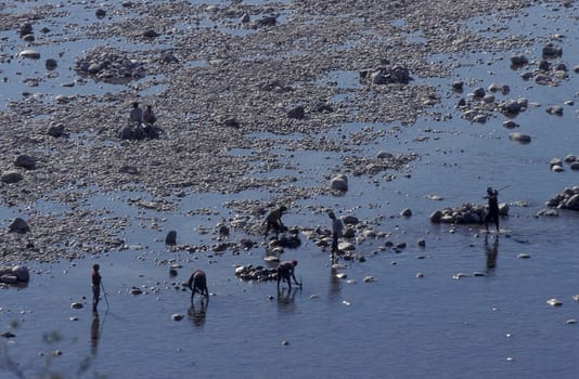 a men and treasure hunter search in the Holy Ganges River in the city of Haridwar in the Province Uttarakhand in India.  India, Haridwar, February, 1998