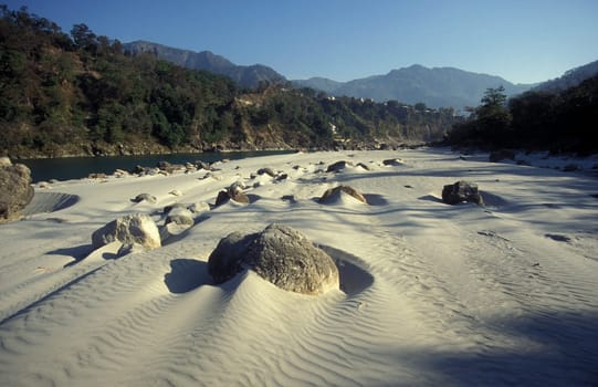 a sand dunes and Beach at the Holy Ganges River with the city of Rishikesh in the Province Uttarakhand in India.  India, Rishikesh, February, 1998