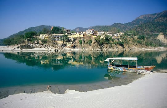 the Holy Ganges River with the city of Rishikesh in the Province Uttarakhand in India.  India, Rishikesh, February, 1998