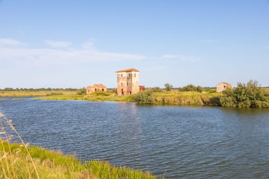 Italy, Comacchio lagoon with blue sky. Panorama with country and canals.