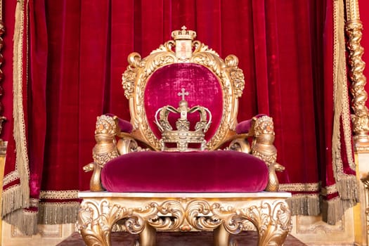 Genoa, Italy - 06 August 2023: Royal Palace, throne room interior, gold and red velvet