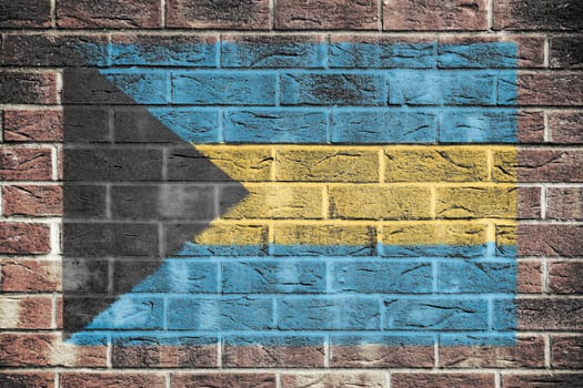 A Bahamas flag on a brick wall background