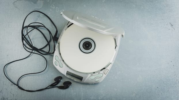 Close up of a vintage portable compact disc player on metal background.