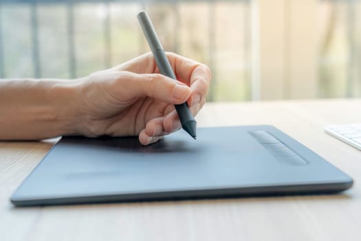 Close up of a hand using graphics tablet for video art.