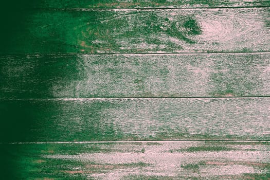 Close-up of weathered wooden planks with faded green paint giving them a rustic and antique look, background image