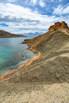 Il-Qarraba, stunning privileged viewpoint over both Riviera Bay locally known as Ghajn Tuffieha Bay and Qarraba Bay with red sand. Malta