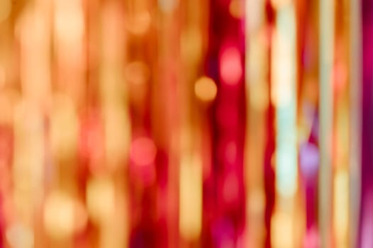 Blurred background of colorful red and gold Christmas festive bokeh lights