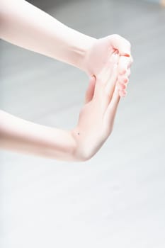 hands performing a wrist and forearm stretch, useful for relieving tendinitis, repetitive strain injuries, and carpal tunnel syndrome. Focus on proper hand and arm positioning