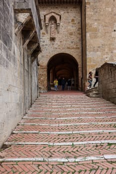 San Gimignano, Italy - Sept 17, 2022: Entrance to the Courtyard of Palazzo Comunale, also known as the Palazzo del Popolo in San Gimignano. Tuscany, Italy