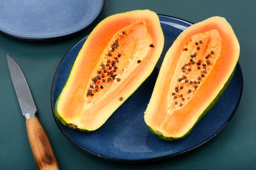 Sliced fresh juicy papaya on the table. Space for text.