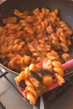 pasta swordfish and eggplant in pan