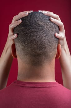 hands of a white woman are gently holding a black man's shaved head. This scene represents inclusivity, gender fluidity, non-binarism, LGBTQIA+ acceptance, and woke cultural values
