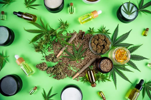 Composition with marijuana leaves, bottle of oil, cannabis on cbd