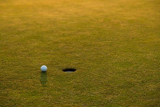 Closeup Golf ball on green grass on course