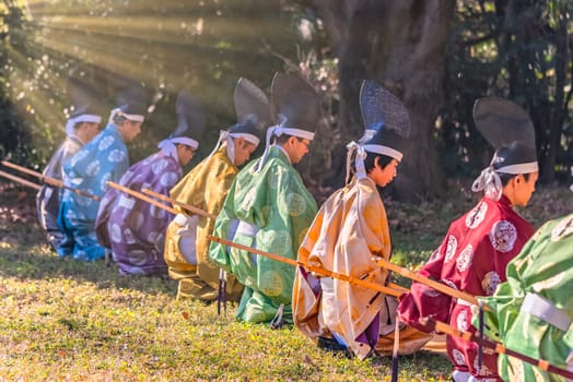 tokyo, yoyogi - jan 13 2024: Archers dressed in kimono wearing eboshi hats perform a traditional Japanese Momoteshiki archery ritual in Meiji Jingu Shrine preserving a cultural heritage of Japan.