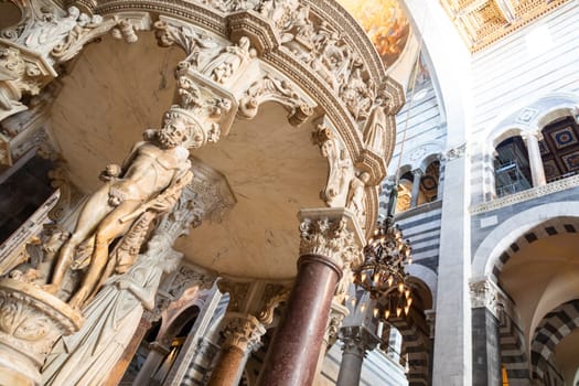 Pisa, Italy - 29 June 2023. Cathedral interior. The pulpit, Medieval art masterpiece by sculptor Giovanni Pisano, 1310