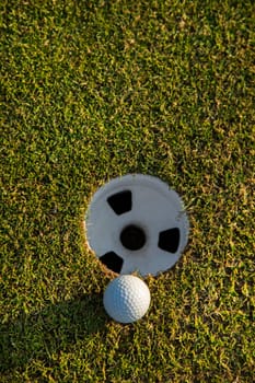 Golf ball and clubs in golf field