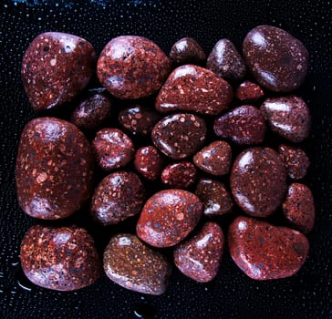 Wet black stones on a dark background