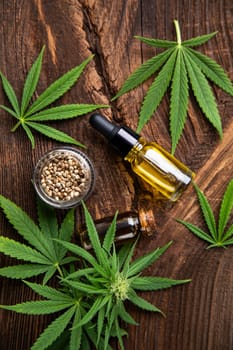 Cannabis oil bottle and marijuana leaves