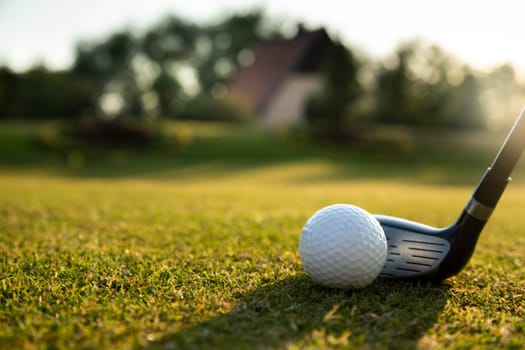 Golf player playing in a golf club on a beautiful sunset in the evening