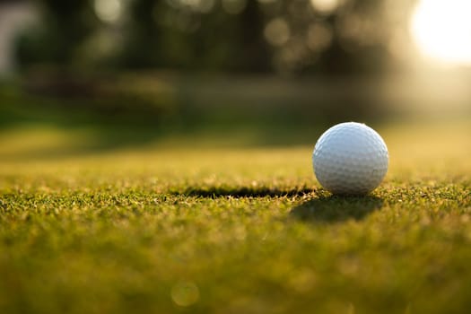 Closeup Golf ball on green grass on course