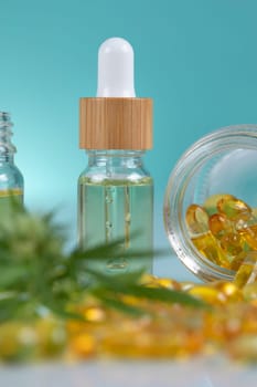 Cannabis leaf and capsules cbd on a white background. top view