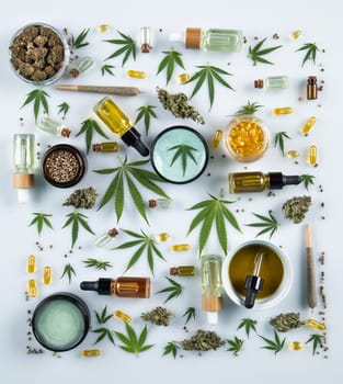 Flat lay composition with marijuana leaves, bottle of oil, cannabis on cbd, white background