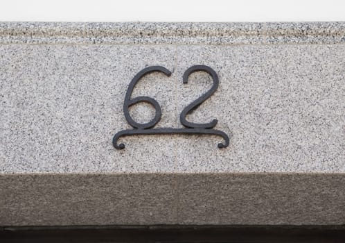 House number 62. Iron over granite lintel. Houses with personality concept