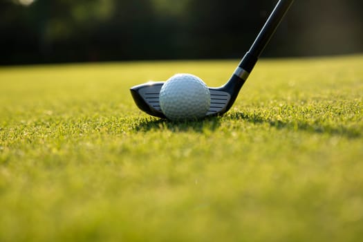Golf player playing in a golf club on a beautiful sunset in the evening