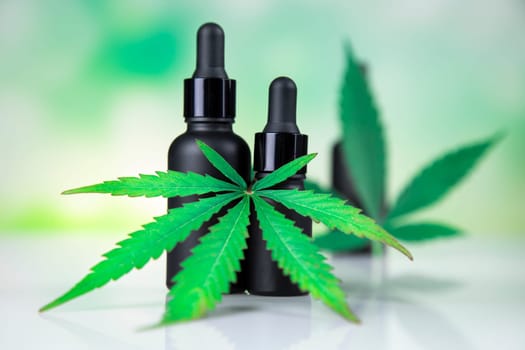 Hemp cbd oil, cannabis leaves, hemp seeds and bottles of oil