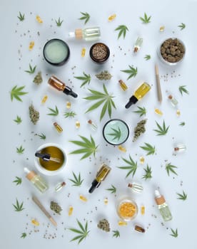 Top view of marijuana leaves and cannabis buds on white background