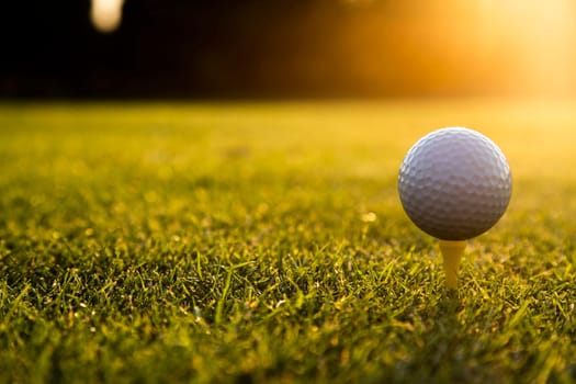 Golf ball and clubs in golf field