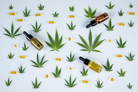 Top view of marijuana leaves and cannabis buds on white background