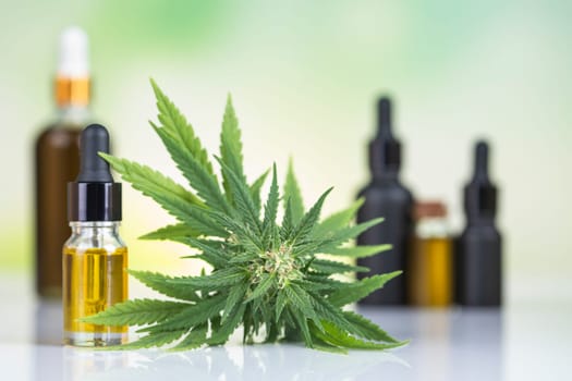 Bottles with hemp oil and cannabis leaves, marijuana