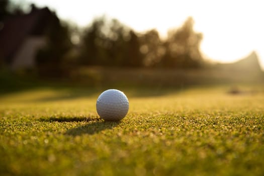 Closeup Golf ball on green grass on course
