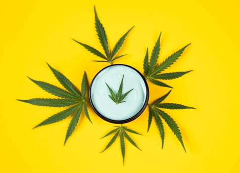 Set of cannabis oil bottles with hemp oil on yellow background. top view. flat lay