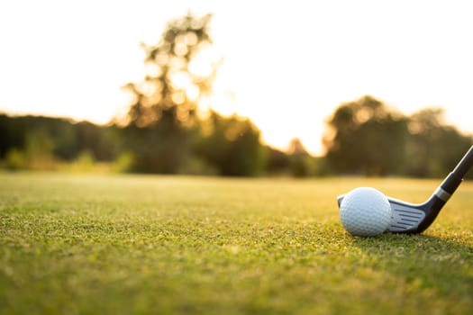 Playing a golf on a beautiful sunset in the evening