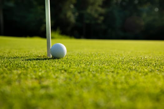Golf ball and clubs in golf field