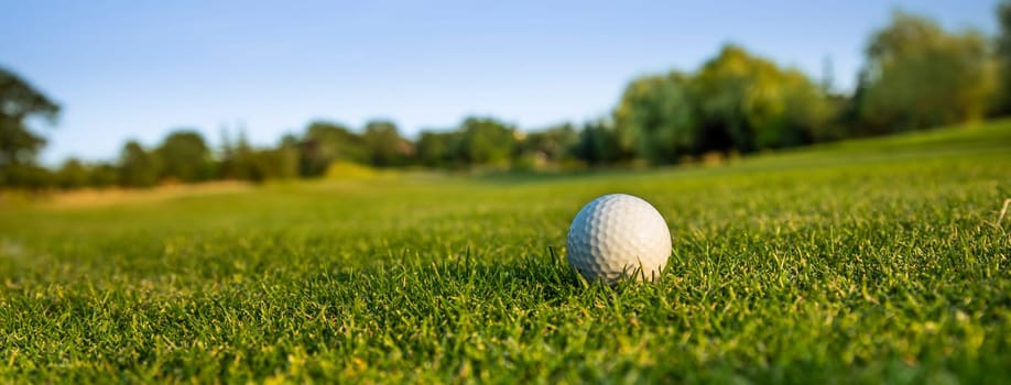 Golf ball and clubs in golf field