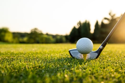 Playing a golf on a beautiful sunset in the evening