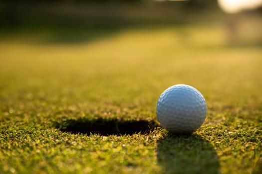 Golf ball and clubs in golf field