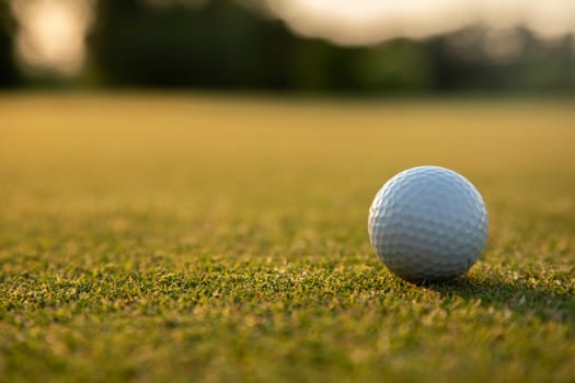 Golf ball and clubs in golf field
