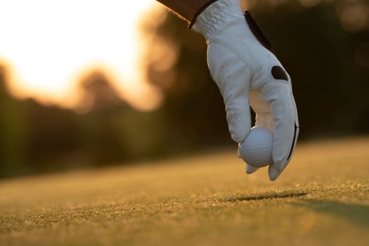 Golf course with ball and grass on close up of a hand     ,grass,golfer,golfing,sky,nature,ball,object,play,blue,fairway,closeup,club,outdoor     ,competition,recreation,background,color,summer