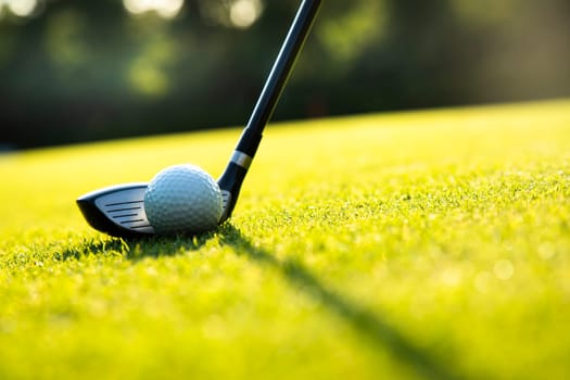 Golf player playing in a golf club on a beautiful sunset in the evening