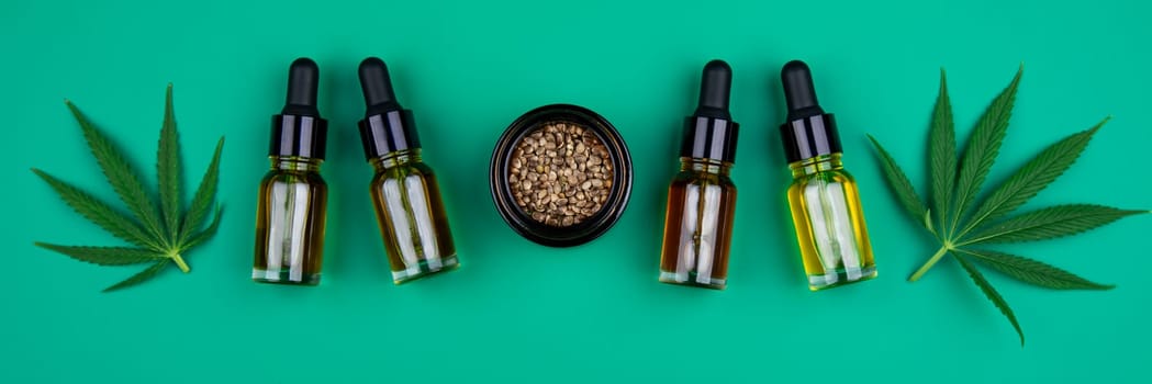 Flat lay composition with marijuana leaves, bottle of oil, marijuana and cannabis on cbd