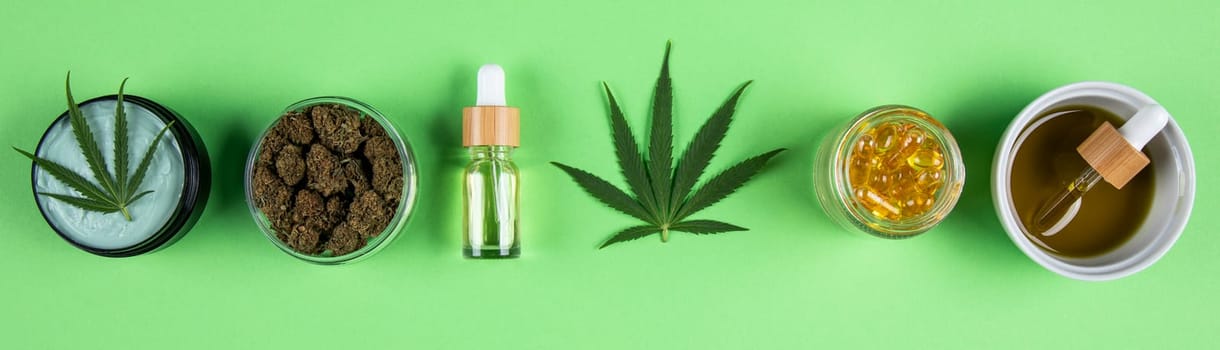 Composition with marijuana leaves, bottle of oil, cannabis on cbd