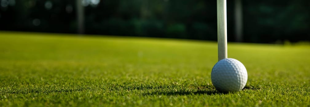Golf ball and clubs in golf field