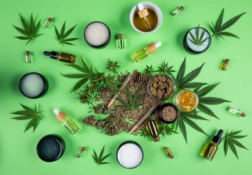 Composition with marijuana leaves, bottle of oil, cannabis on cbd