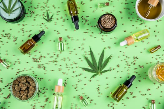 Composition with marijuana leaves, bottle of oil, cannabis on cbd